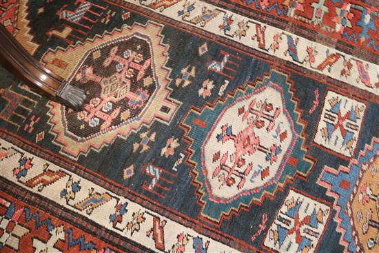 A Kazak blue ground runner, c.1880, 11ft 8in by 3ft 8in.